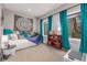 Cozy bedroom with a daybed, window seating, and teal curtains at 1468 S Washington St, Denver, CO 80210