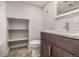 Basement bathroom with toilet, sink, and built-in shelving at 1468 S Washington St, Denver, CO 80210
