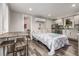 Studio apartment bedroom with a comfortable bed and kitchenette at 1468 S Washington St, Denver, CO 80210