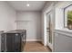Basement laundry room with washer, dryer, and exterior access at 1468 S Washington St, Denver, CO 80210