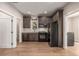 Modern kitchen with dark cabinets and stainless steel appliances at 1468 S Washington St, Denver, CO 80210