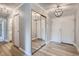 Bright entryway with mirrored closet doors and wood-look flooring at 3164 S Wheeling Way # 308, Aurora, CO 80014