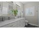 Bathroom with double vanity, marble countertops, and hexagon tile at 4155 S Delaware St, Englewood, CO 80110