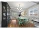 Light and airy dining area with a light teal table and chairs, adjacent to the kitchen at 4155 S Delaware St, Englewood, CO 80110