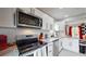 Modern kitchen featuring stainless steel appliances and white shaker cabinets at 730 E Alameda Ave, Denver, CO 80209
