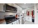 Modern kitchen featuring stainless steel appliances and white shaker cabinets at 730 E Alameda Ave, Denver, CO 80209