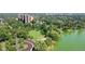 Aerial view of a lakefront property with lush green park and cityscape in the background at 730 E Alameda Ave, Denver, CO 80209