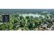 Aerial view showcasing a tranquil lake surrounded by trees and high-rise building at 730 E Alameda Ave, Denver, CO 80209