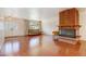 Living room with hardwood floors and brick fireplace at 3278 S Oneida Way, Denver, CO 80224