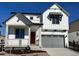 Two-story house with gray garage door and red front door, charming landscaping at 8084 Butte Creek St, Littleton, CO 80125