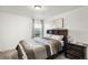 Bright bedroom with double bed and nightstand at 10150 E Virginia Ave # 2-205, Denver, CO 80247