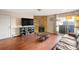 Bright living room with stone fireplace, hardwood floors, and access to balcony at 10150 E Virginia Ave # 2-205, Denver, CO 80247