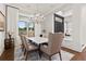 Elegant dining room with marble table and chandelier, hardwood floors, and natural light at 726 Evening Star Dr, Castle Rock, CO 80108