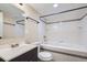 Basement bathroom with tub, toilet, sink, and mirror at 5353 Quitman St, Denver, CO 80212