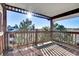 Wooden balcony with view of trees and sky at 17662 E Loyola Dr # 2132L, Aurora, CO 80013