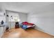 Simple bedroom with wood floors and a window at 17662 E Loyola Dr # 2132L, Aurora, CO 80013