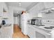 White kitchen with appliances and granite countertops at 17662 E Loyola Dr # 2132L, Aurora, CO 80013