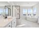 Main bathroom with soaking tub, shower, and dual sinks at 1742 Morgan Dr, Erie, CO 80516