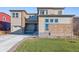 Two-story house with stone and light-brown siding, two-car garage, and landscaping at 1742 Morgan Dr, Erie, CO 80516