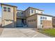 Two-story house with stone and light-brown siding, two-car garage, and landscaping at 1742 Morgan Dr, Erie, CO 80516