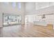 Open concept great room and kitchen with hardwood floors, island, and high ceilings at 1742 Morgan Dr, Erie, CO 80516