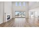 Spacious great room with hardwood floors, fireplace, and sliding glass doors at 1742 Morgan Dr, Erie, CO 80516