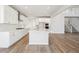 Modern kitchen with white cabinets, island, and stainless steel appliances at 1742 Morgan Dr, Erie, CO 80516