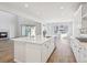Bright kitchen features an island, stainless steel appliances, and white cabinets at 1742 Morgan Dr, Erie, CO 80516