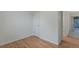 Hallway with light walls, hardwood floors, and a door at 8467 W 62 Pl, Arvada, CO 80004