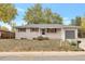 Ranch-style home with attached garage and mature landscaping at 8467 W 62 Pl, Arvada, CO 80004