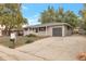 Ranch style home with attached garage and mature landscaping at 8467 W 62 Pl, Arvada, CO 80004