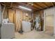 Unfinished laundry room with washer, dryer and water heater at 8467 W 62 Pl, Arvada, CO 80004