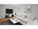 Virtually staged living room featuring an L-shaped sofa at 8467 W 62 Pl, Arvada, CO 80004