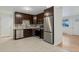 Kitchen features dark brown cabinets and stainless steel appliances at 8467 W 62 Pl, Arvada, CO 80004