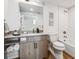 Modern bathroom with subway tile and wood floors at 3575 Chestnut Pl # 605, Denver, CO 80216