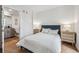 Bedroom with ensuite bathroom and wood floors at 3575 Chestnut Pl # 605, Denver, CO 80216