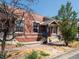 Brick house with front porch, steps, and For Sale sign at 160 S Cherokee St, Denver, CO 80223