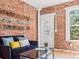 Living room with exposed brick wall and comfy seating at 160 S Cherokee St, Denver, CO 80223