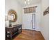 Bright and airy entryway with hardwood floors and a stylish console table at 8726 Holman Cir, Arvada, CO 80005