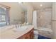 Bathroom with tile shower, bathtub, and vanity with wood cabinets at 518 S Ridge St # 518, Breckenridge, CO 80424