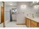 Clean bathroom, featuring a bathtub, shower, and wood vanity at 33804 Bergen View Trl, Evergreen, CO 80439