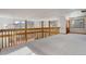 Upstairs loft area with carpeted floors and mountain views from large windows at 33804 Bergen View Trl, Evergreen, CO 80439