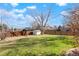 Large backyard with grassy area, shed, and wooden fence at 11102 Zephyr St, Westminster, CO 80021