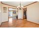 Formal dining room with hardwood floors, chandelier and kitchen access at 11102 Zephyr St, Westminster, CO 80021