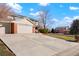 Two-story house with brick front and attached two-car garage, long driveway at 11102 Zephyr St, Westminster, CO 80021