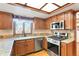Kitchen with granite countertops, stainless steel appliances, and wood cabinets at 11102 Zephyr St, Westminster, CO 80021