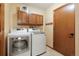 Laundry room with washer, dryer, and additional storage at 11102 Zephyr St, Westminster, CO 80021