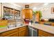 Kitchen with wood cabinets, stainless steel appliances, and double sink at 803 Buchanan Ln, Longmont, CO 80504