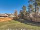 Fenced backyard with a grassy lawn and mature trees at 4446 S Xenia St, Denver, CO 80237