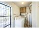 Laundry room with washer, dryer, and exterior access at 1646 S Winona Ct, Denver, CO 80219